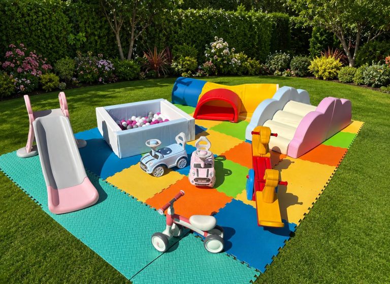 Outdoor soft play hire setup in Thanet with slide, ball pit, ride‑on cars and toddler play equipment.